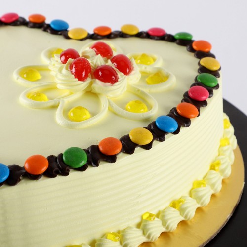 Heart Shaped Butterscotch Gems Cake Delivery in Noida
